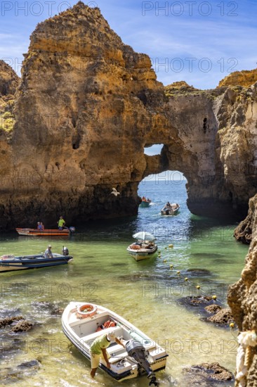 Excursion boats at the caves and rocky gates of the Ponta da Piedade rocky coast, rugged coastal