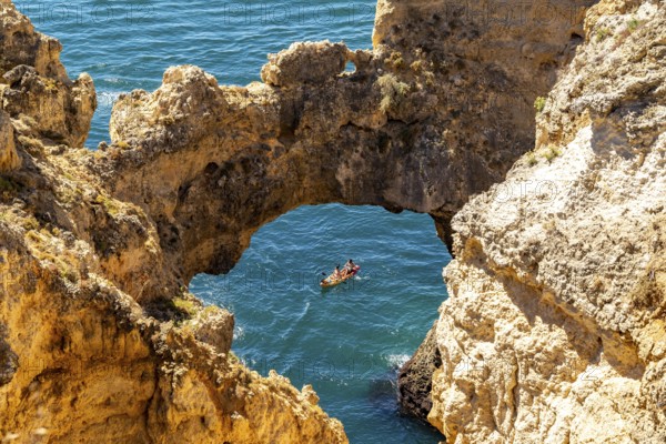 Excursion boats at the caves and rocky gates of the Ponta da Piedade rocky coast, rugged coastal