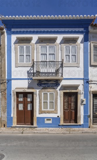 Facade of buildings decorated with tiles, azulejos, coloured tiles on facades, in Tavira, old town,