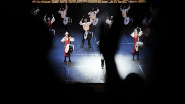 Dozens of members of Fire of Anatolia perform a drumming sequence during a cultural festival at