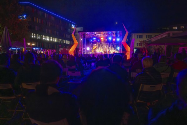 Concert stage illuminated at night with audience and atmospheric lighting effects, Sindelfingen,