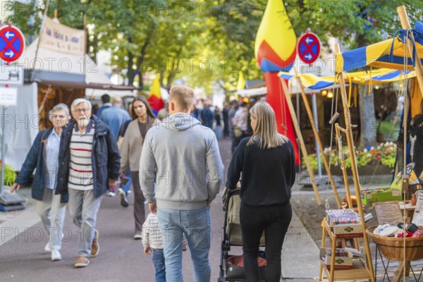 People strolling through an autumnal market with various colourful stalls, Sindelfingen, Böblingen