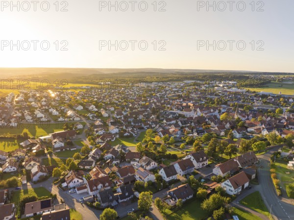 Aerial view of a village at sunset with densely built-up houses and rural flair, Althengstett,