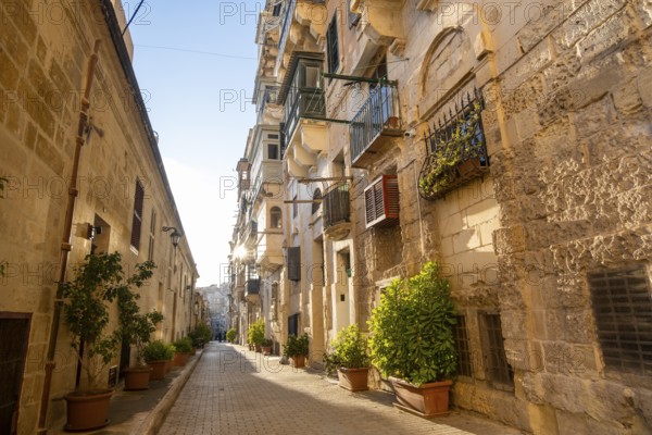 Street with wonderful historic houses with colorful wooden balconies in La Valletta, capital city