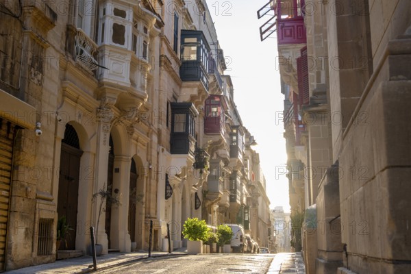 Street with wonderful historic houses with colorful wooden balconies in La Valletta, capital city