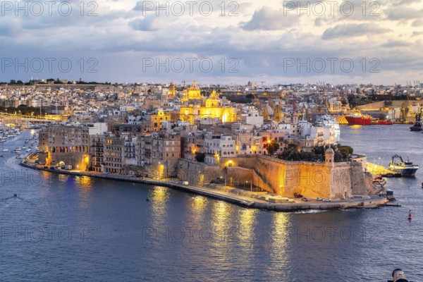 Beautiful evening view of illuminated Valletta, Birgu with Saint Angelo Fortress, capital city of
