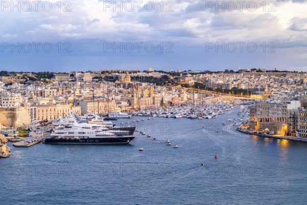 Beautiful evening view of illuminated Valletta, Birgu with Saint Angelo Fortress, capital city of