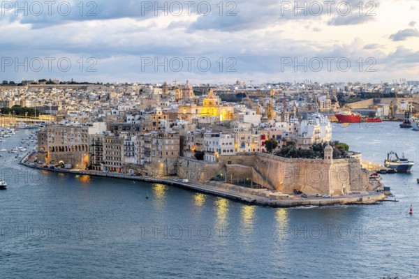 Beautiful evening view of illuminated Valletta, Birgu with Saint Angelo Fortress, capital city of