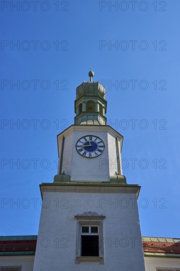 Historic clock tower against a bright blue sky. Baroque architecture with clear lines, brewhouse am