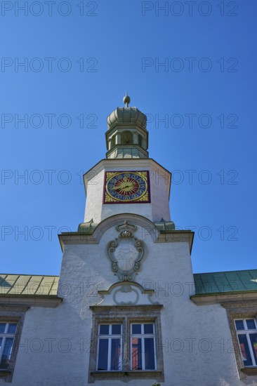 Tower clock on a historic building under a clear blue sky. Impressive baroque architecture,