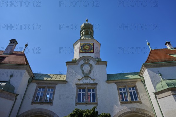 Historic building with tower and clock under a radiant sky. Baroque details and symmetrical design,