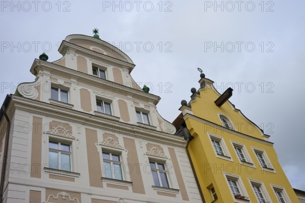 Detailed view of decorated facades of historic buildings under a cloudy sky, Regensburg, Bavaria,