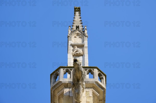 Detail of a Gothic spire with sculptures in the blue sky, St Peter's Cathedral, Regensburg,