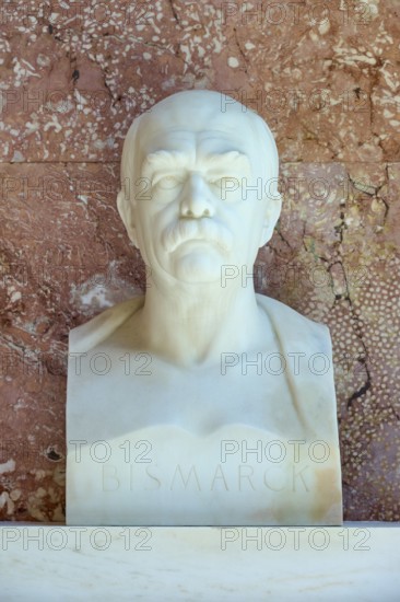 Marble bust of Bismarck against a red background, conveying seriousness and historical