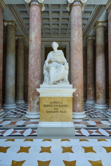 White statue of Ludwig I, surrounded by red marble columns and magnificent floor pattern, Walhalla,