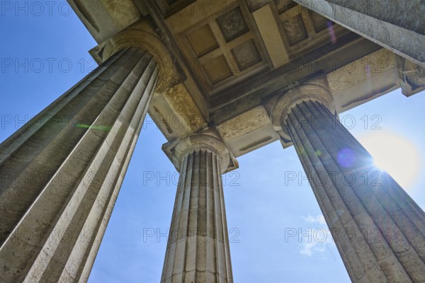 Three massive columns rise up against the blue sky, seen from below, Walhalla, Donaustauf,
