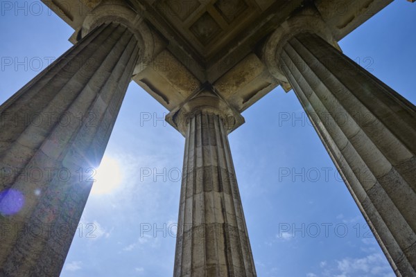 Majestic columns under a bright blue sky, seen from a low perspective, Walhalla, Donaustauf,