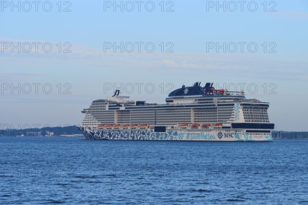 A large cruise ship, MSC Euribia, on the sea with blue sky and clouds, Heikendorf, Plön district,
