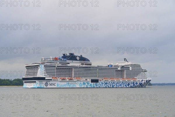 Large cruise ship, MSC Euribia, in calm waters under a cloudy sky, Heikendorf, Plön district, Kiel