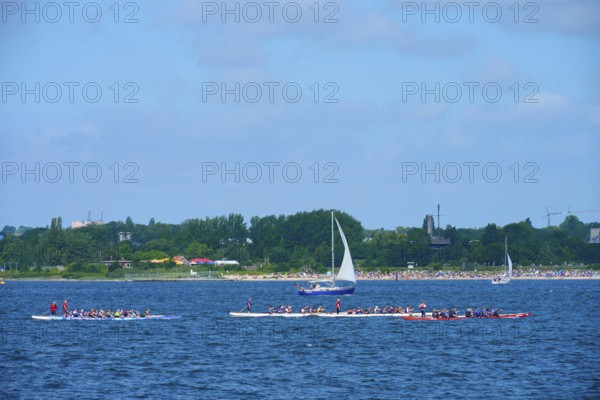 Canoeist and sailing boat on the sea in sunny weather, Heikendorf, Plön district, Kiel Fjord,