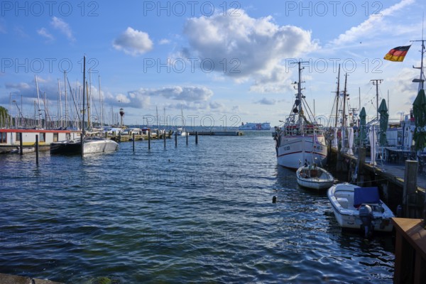Harbour view with moored boats and blowing wind under a blue sky, Heikendorf, Plön district, Kiel