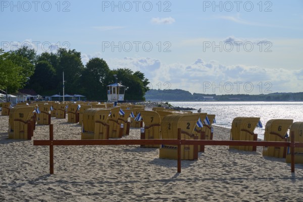 Beach chairs on a quiet beach with blue sky and water in the background under the summer sun,