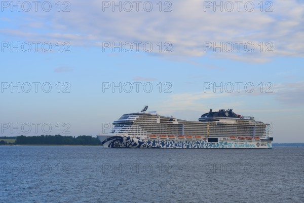 Cruise ship, MSC Euribia, gliding along in front of a wide water landscape, Heikendorf, Plön