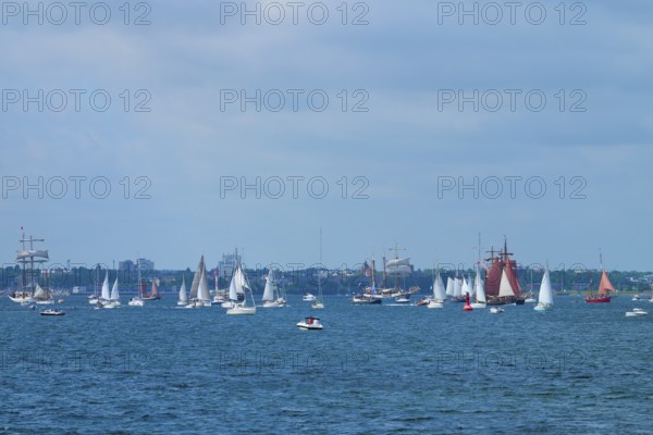 Many sailing boats in front of a city on the blue sea under a partly cloudy sky, Windjammer Parade