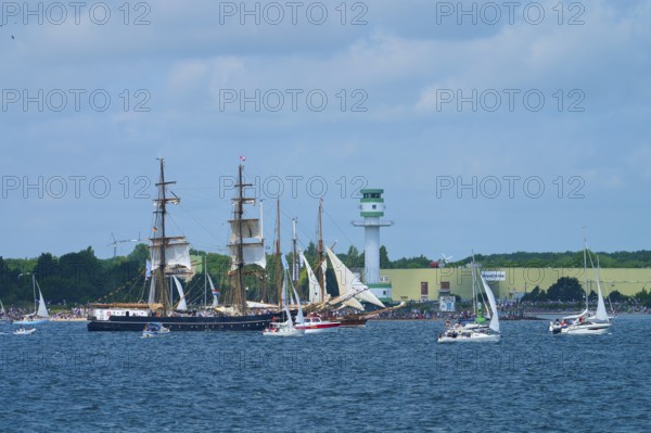Large traditional sailing ship surrounded by sailing boats on the sea near Friedrichsort