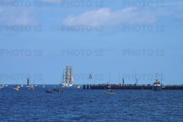 A sailing ship Gorch Fock in the distance, various boats and a jetty in the picture, Windjammer