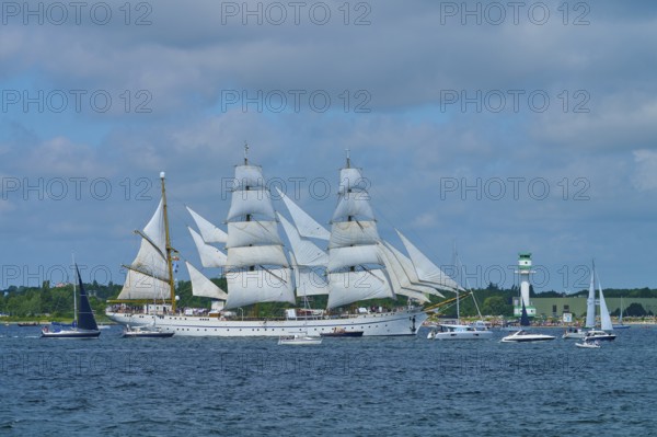 Large sailing ship Gorch Fock with several white sails on the sea under a blue sky, Windjammer