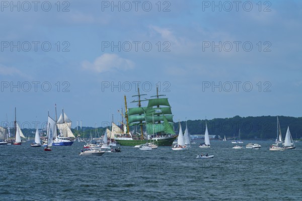 Beautiful view of many sailing boats and a striking green sailing ship Alexander von Humbold 2 in