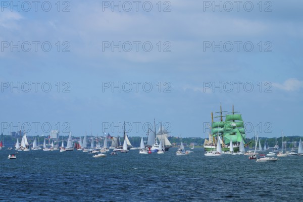Many sailing boats on the ocean, a large sailing ship Alexander von Humbold 2 with green sails