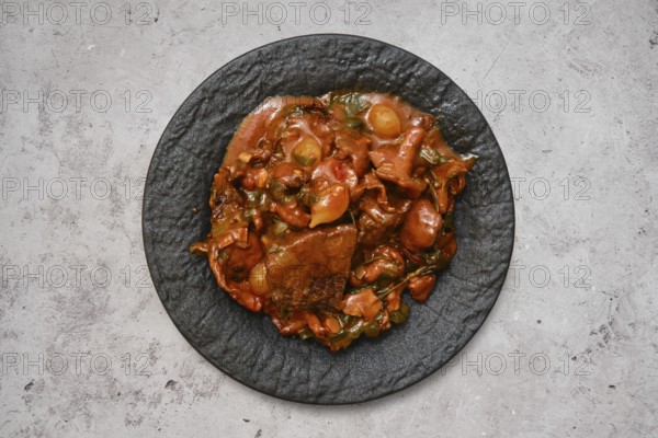 A hearty beef stew featuring tender chunks of meat and fresh vegetables sits invitingly on a