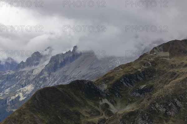 View over the Tremola to the Poncione di Fieud, the peaks of the Bedretto in the clouds, Passo