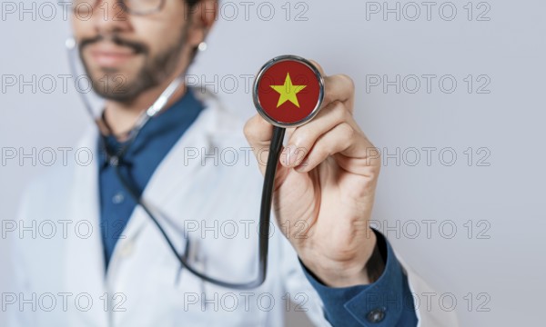Doctor holding stethoscope with Vietnam flag. Vietnam health and care concept, Vietnam flag on