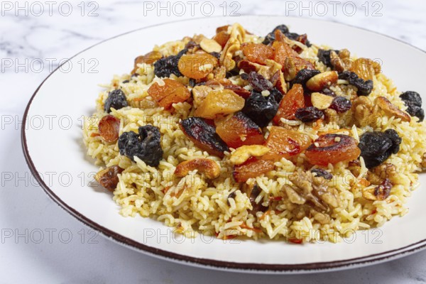 Rice dish, with the addition of dried fruits, nuts and spices of Middle Eastern cuisine, homemade,