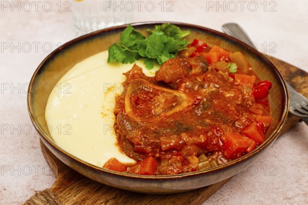 Ossobuco, stewed meat knuckle on the bone, with mashed potatoes, and oats and spices, homemade, no