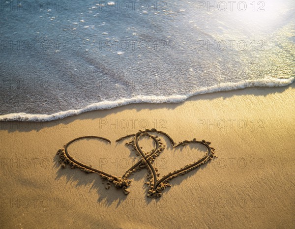 Warm tropical beach with two hearts drawn on the sand, blue waters, and clear skies, invoking