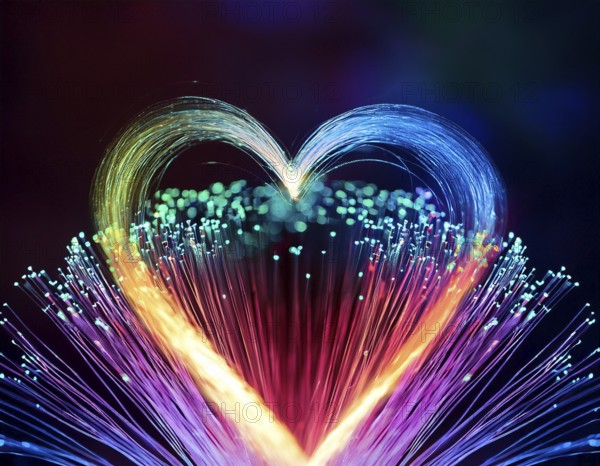 Colorful artistic display featuring vibrant light patterns shaped like a heart, expressing love and