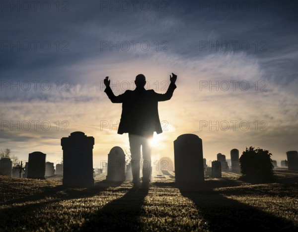 A silhouette of a lone figure walking off a gravestone, The scene evokes Resurrection thoughts