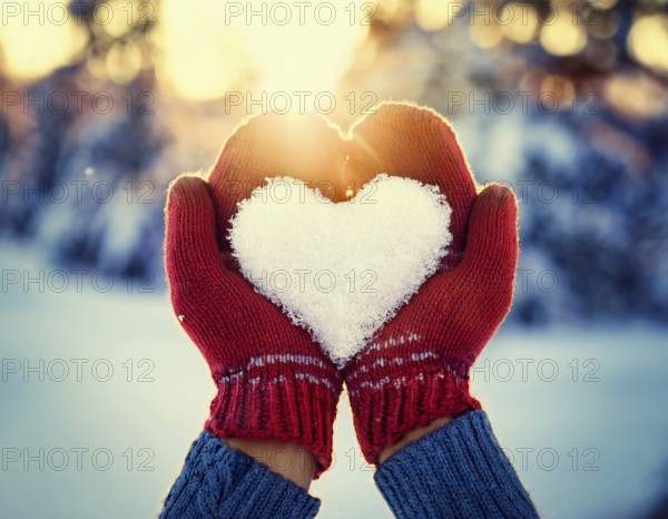 Serene winter scene showcasing hands in gloves holding a snow heart symbolizing love and warmth, AI