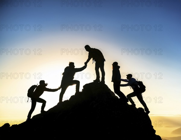 A dynamic depiction of teamwork and determination, climbers ascend a rugged mountain peak during