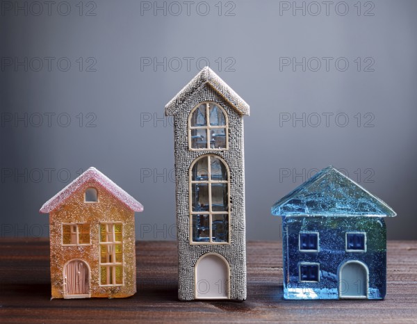 A collection of small glass model houses with cozy lighting, creating a warm and inviting