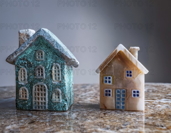 A collection of small model houses with cozy lighting, creating a warm and inviting atmosphere, AI