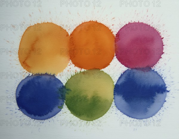 Colorful watercolor circles painted on a white background create a vibrant and artistic design.