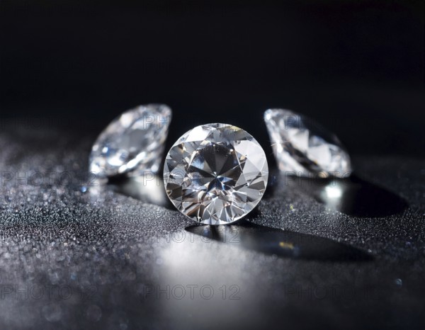 A brilliant collection of diamonds illuminated with striking lighting effects, emphasizing their