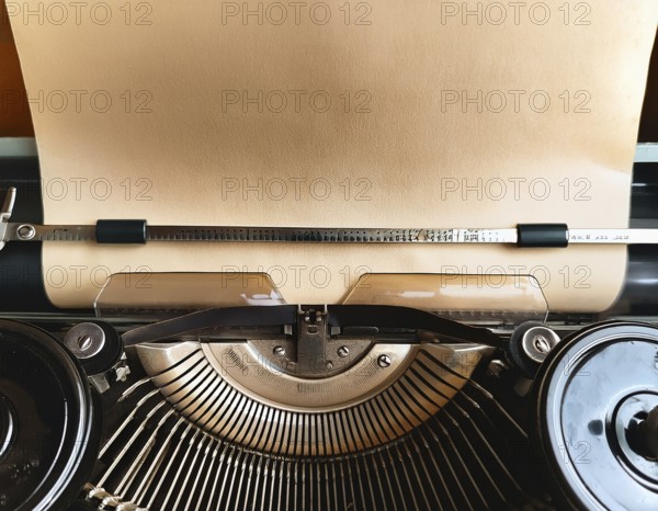 View from above of a retro typewriter equipped with a blank paper sheet, representing creativity,
