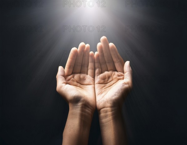 Individual Worship at Home. Image of open hands embracing a radiant light source, embodying