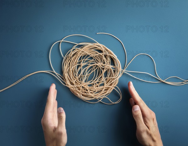 A close-up of a professional ipresenting a piece of intricate, tangled wire, symbolizing